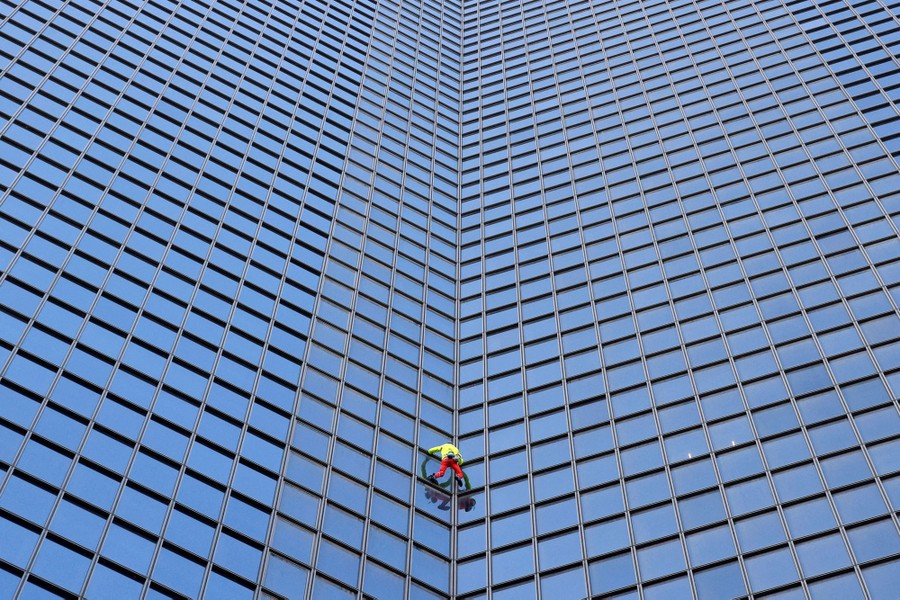 A man scales a skyscraper.