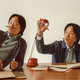 doubled photo with Jimmy O. Yang lying on desk with pen as mustache next to Jimmy adjusting a desk lamp