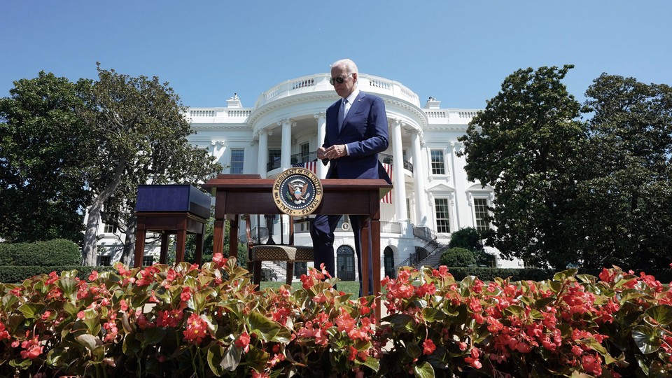 Joe Biden walks up to a small "bill signing" desk in the White House Rose Garden in the photo taken yesterday.