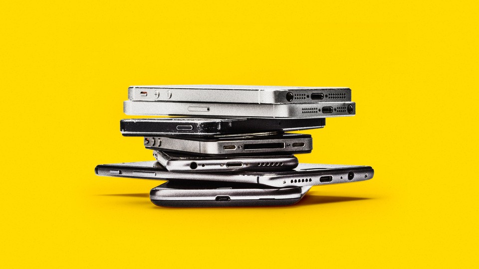 A photograph of several smartphones stacked on top of one another