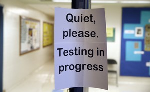 A sign asking people to be quiet while testing takes place
