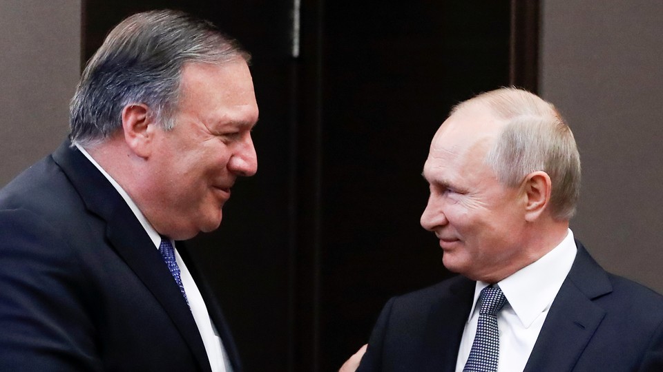 Mike Pompeo and Vladimir Putin greet each other before a meeting in Sochi, Russia.