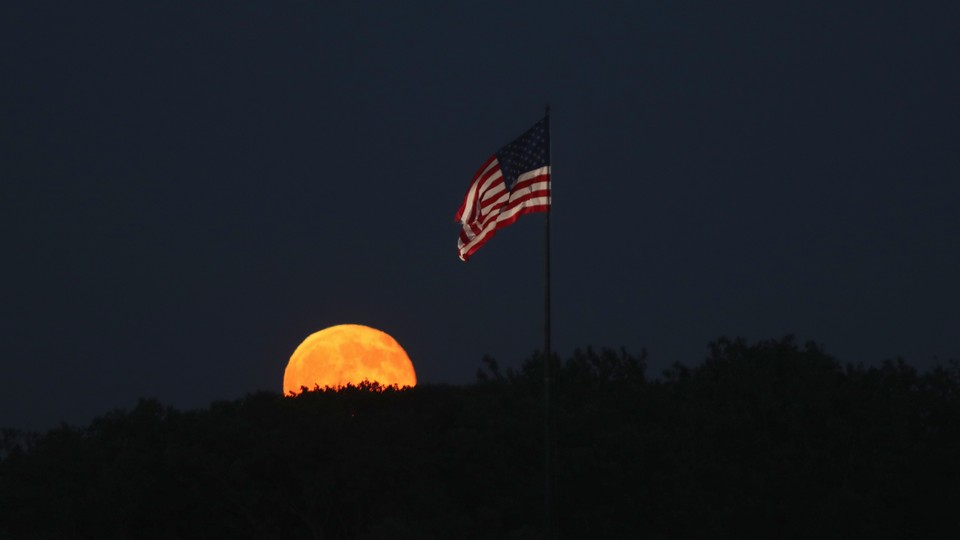 A full moon and the American flag.