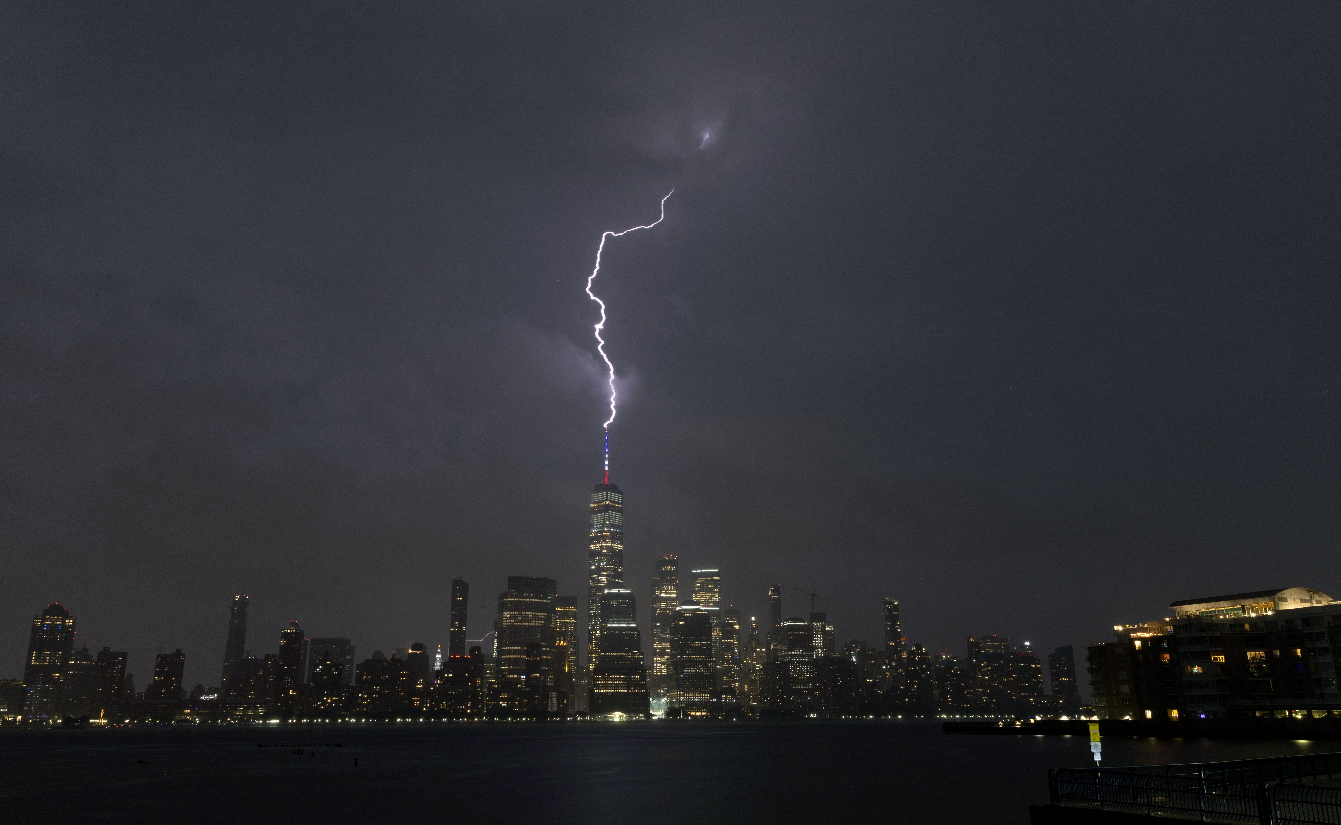 A lightning bolt strikes One World Trade Center during a thunderstorm in New York City.