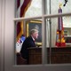 Trump in the Oval Office, seen through a window