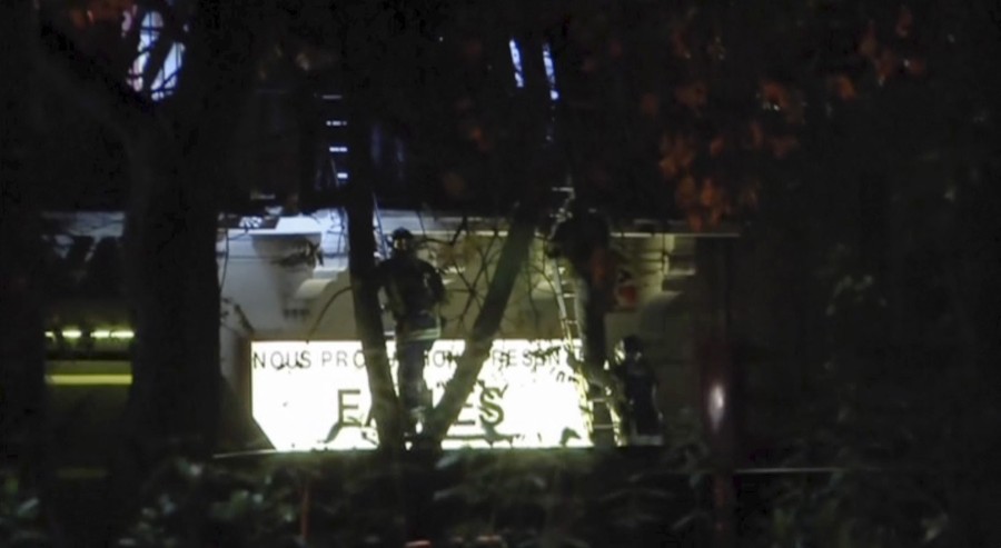 A firefighter climbs a ladder