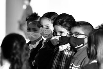 A row of children in face masks