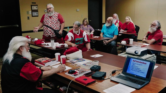 Men and women gather in a classroom for lessons on being Santa.