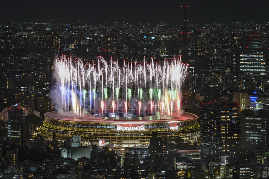 Fireworks light up the sky above a stadium.