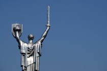 The Mother Motherland Monument statue in Kiev, showing a woman holding up a shield and sword