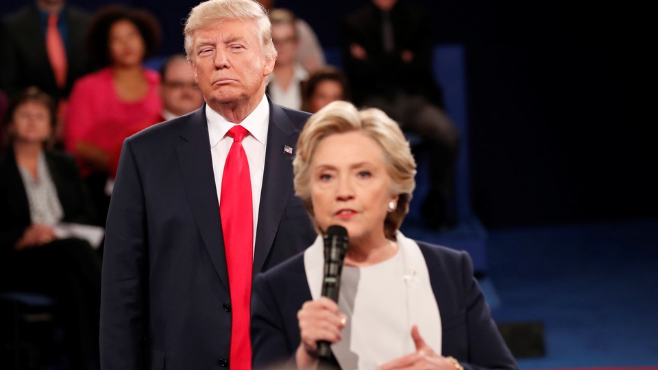 Donald Trump watches Hillary Clinton during a 2016 presidential debate.
