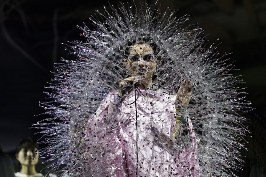 The performer Bjork sings onstage, wearing an unusual spiky costume.