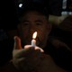 Man holding a candle at vigil after mass shooting in El Paso