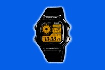 image of a black Casio World Time watch against a blue background