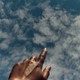 a photo of a hand outstretched toward the sky