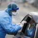 A health worker testing a patient at a drive through center in Seattle, Washington.