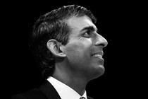 A photo of Rishi Sunak in profile, set against a black background