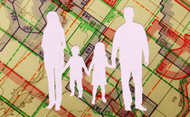 A silhouette of a nuclear family set against a map