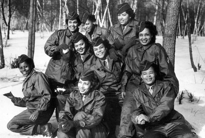 A group of 9 African American women in uniform smile for a group photo