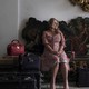 Jennifer Coolidge's Tanya sits surrounded by her luggage in a scene from "The White Lotus"