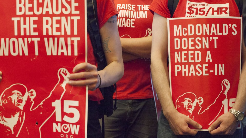 Supporters of a $15 minimum wage at a Seattle City Council meeting in June 2014