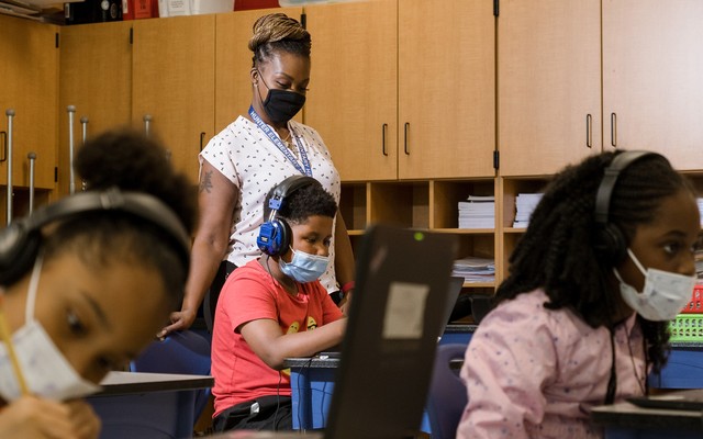 Tonette McQueen helps Zion Graham, 8, with a summer school assignment at Hunter Elementary in Greensboro, North Carolina., July 19, 2021.
