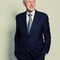 An image of Bill Clinton. He has grey-white hair, and is wearing a blue tie.