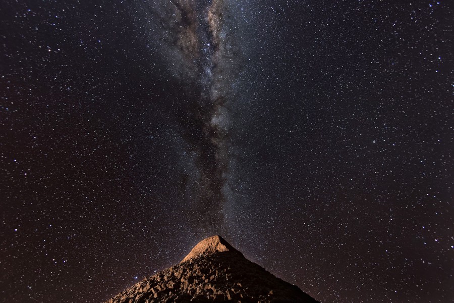 A night view of the Milky Way above a desert mountain