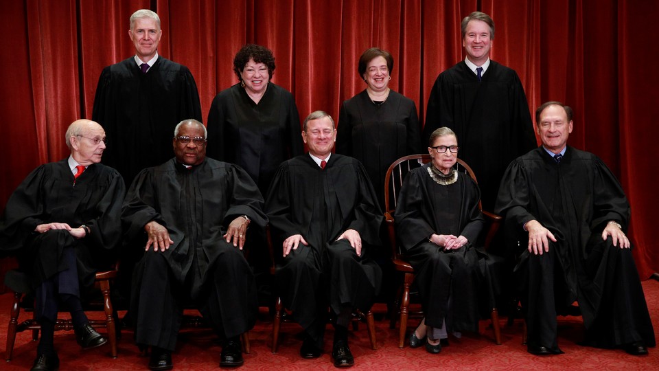 The U.S. Supreme Court justices pose for their group portrait on November 30, 2018.