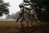 Two female soldiers running