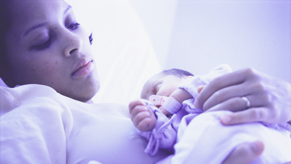 Photograph of a mother holding a newborn baby