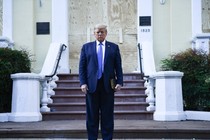 Donald Trump stands in front of a church holding a Bible