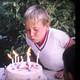A boy blowing out candles on a birthday cake