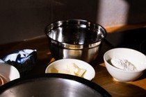 Photograph of bowls containing flour, butter, eggs, and other baking ingredients