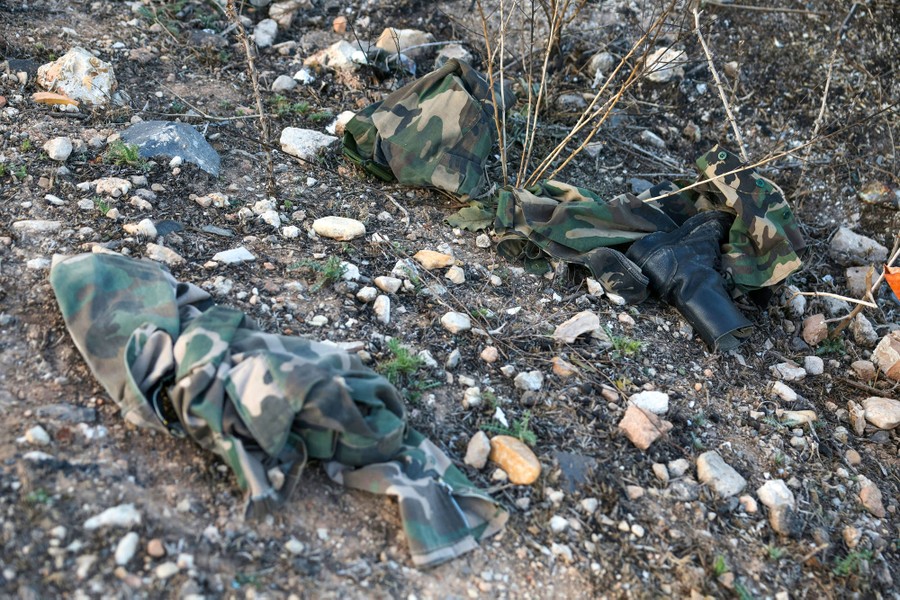Discarded fatigues and boots lie on the ground.