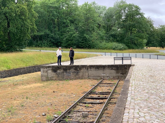 The author stands on the train platform at Buchenwald