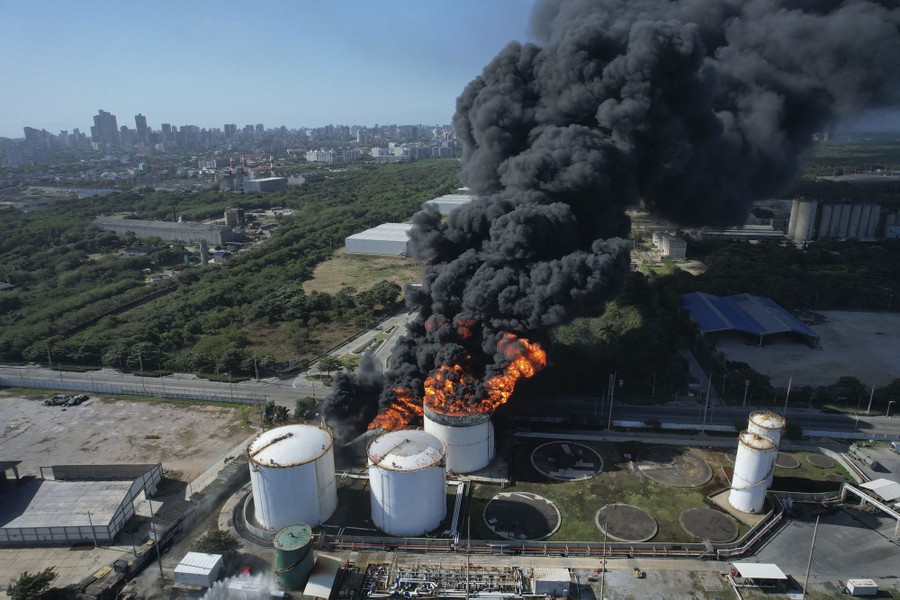 An aerial view of a large fire burning at a gas storage facility.