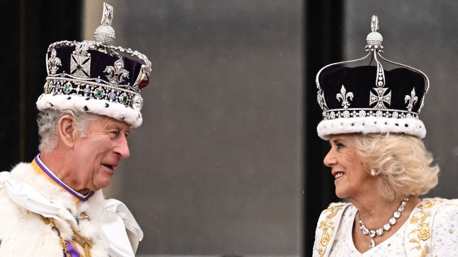King Charles and Queen Camilla, each wearing a crown, face each other.