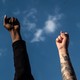 Two fists raised to the sky