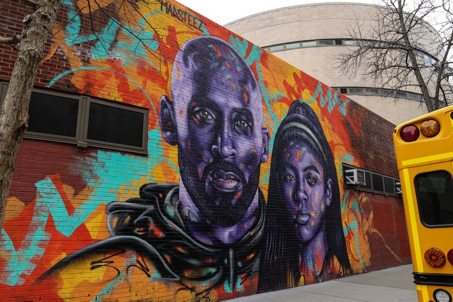 A view of a mural of Kobe Bryant and his daughter Gianna Bryant, painted on the side of a one-story building.