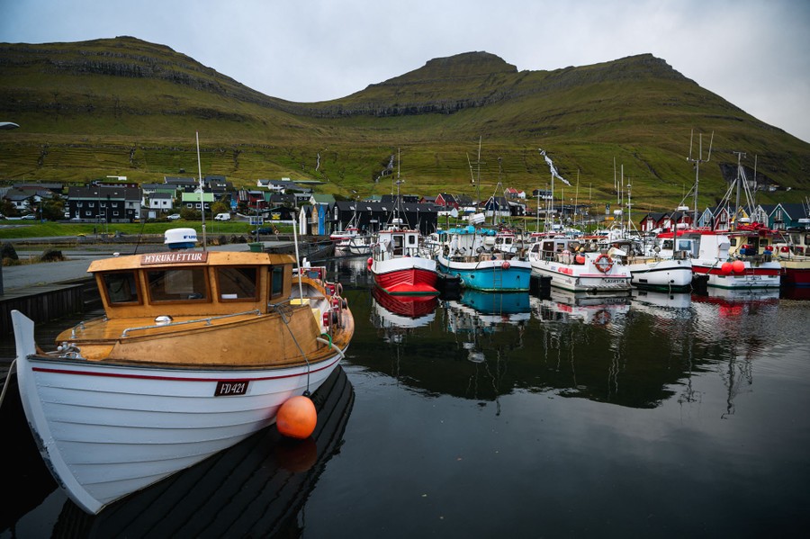 Small fishing boats are seen docked in a harbor.
