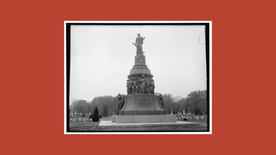 A black-and-white photograph of the Reconciliation Memorial against a red background