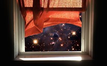An illustration of a window looking out at a simulated Webb view of the cosmos