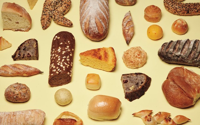 photo of many different types of breads on yellow background