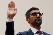 Sundar Pichai raises his right hand.