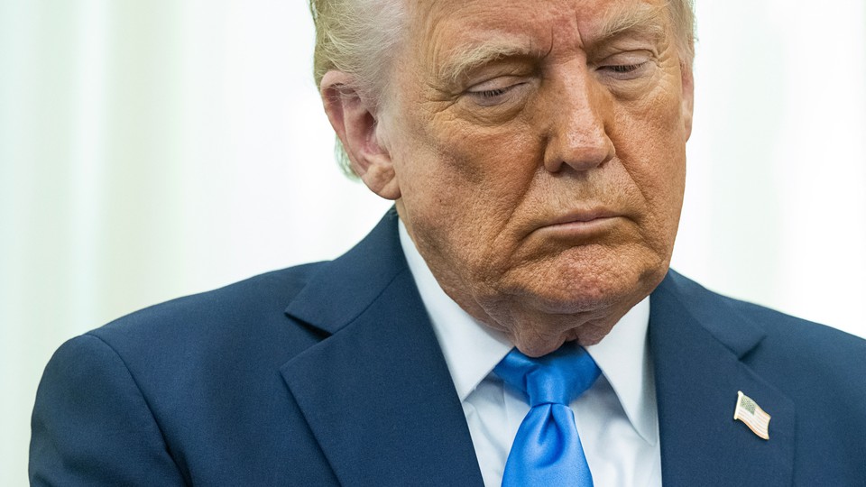A photo of Donald Trump looking down