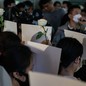 People holding white roses and white pieces of paper to protest China's zero-Covid restrictions in Hong Kong on November 28.