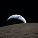 Earth sets behind the moon, as seen by the crew of NASA's Artemis II spacecraft as it swung around the far side of the moon.