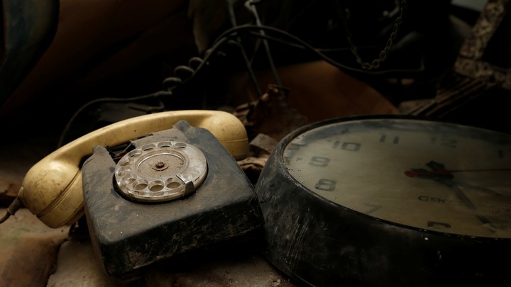 A rotary telephone and clock are seen in the NATO tunnels dating back to the Cold Warbeneath Valletta, Malta, in 2017.