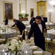 A butler pours wine before a congressional dinner at the White House.